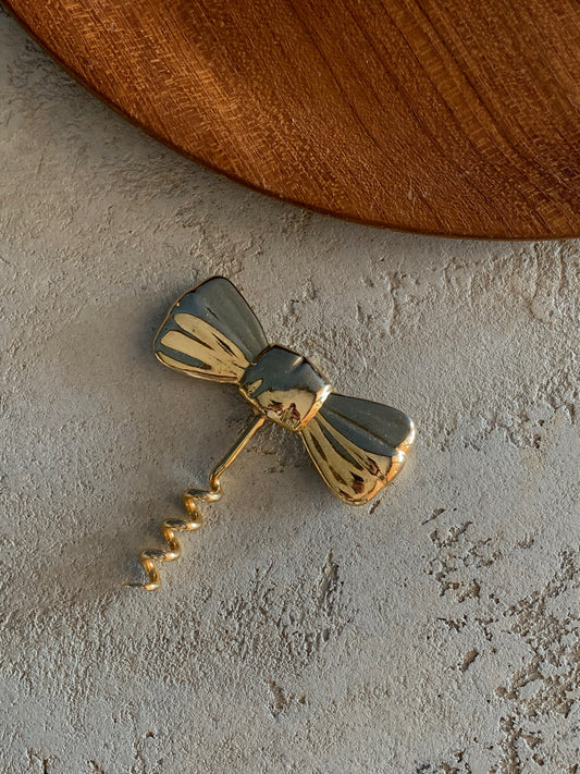 Tire bouchon noeud doré